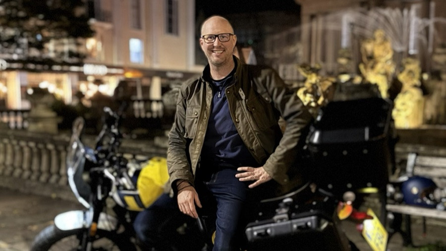 Barrie, the Heat Pump Biker, sitting on his motorbike