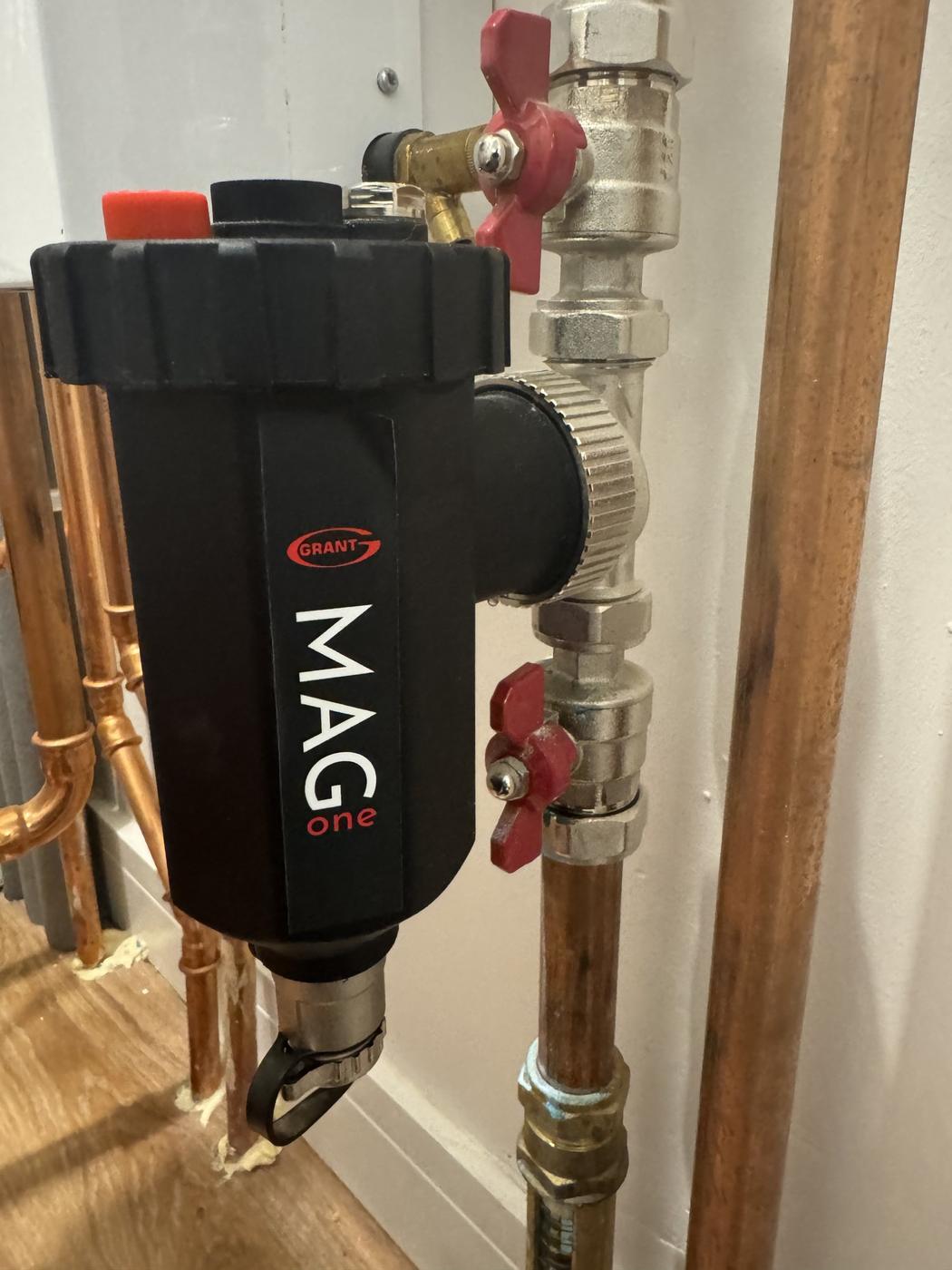 Magnetic system filter on copper pipework, cleaned during an annual service