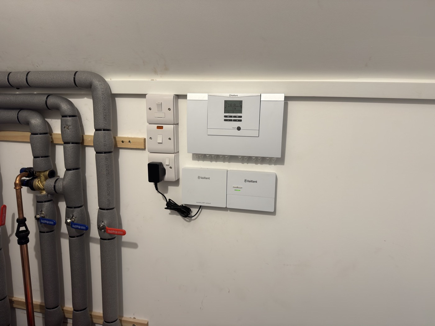 Heat pump wall-mounted controller and switches close up