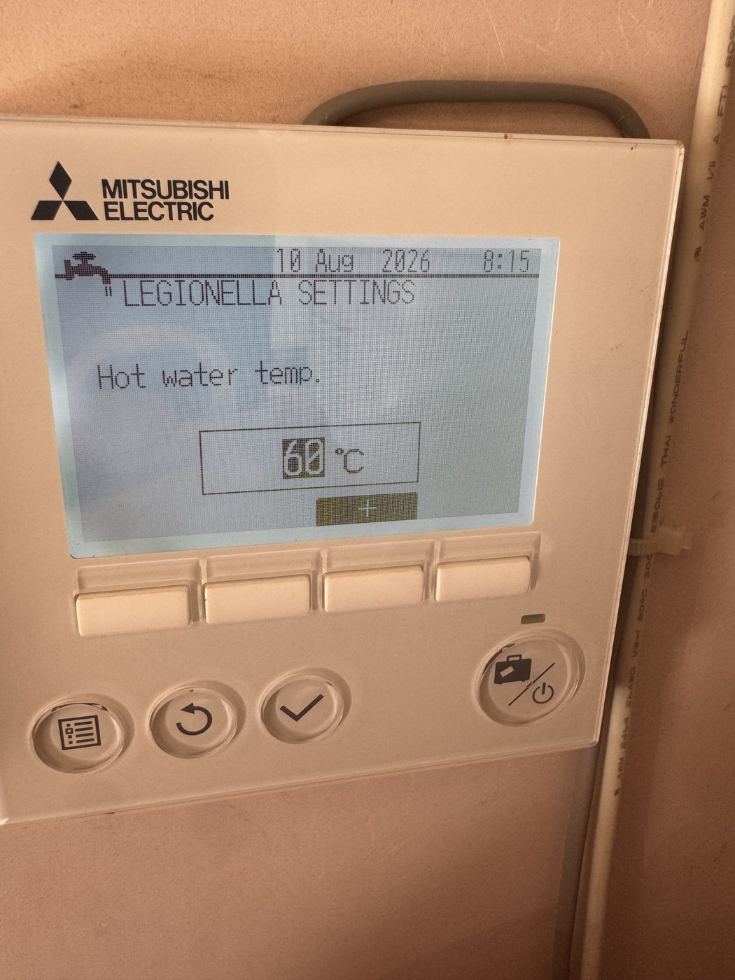 A heat pump controller showing the Legionella cycle hot water temperature set to 60 degrees