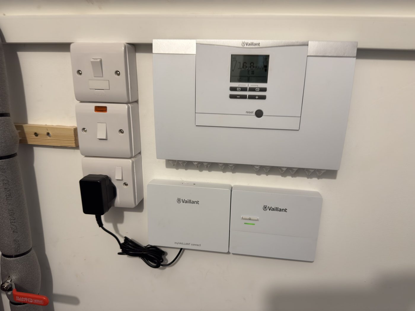 A Vaillant control unit and receivers on the wall, set up during a visit