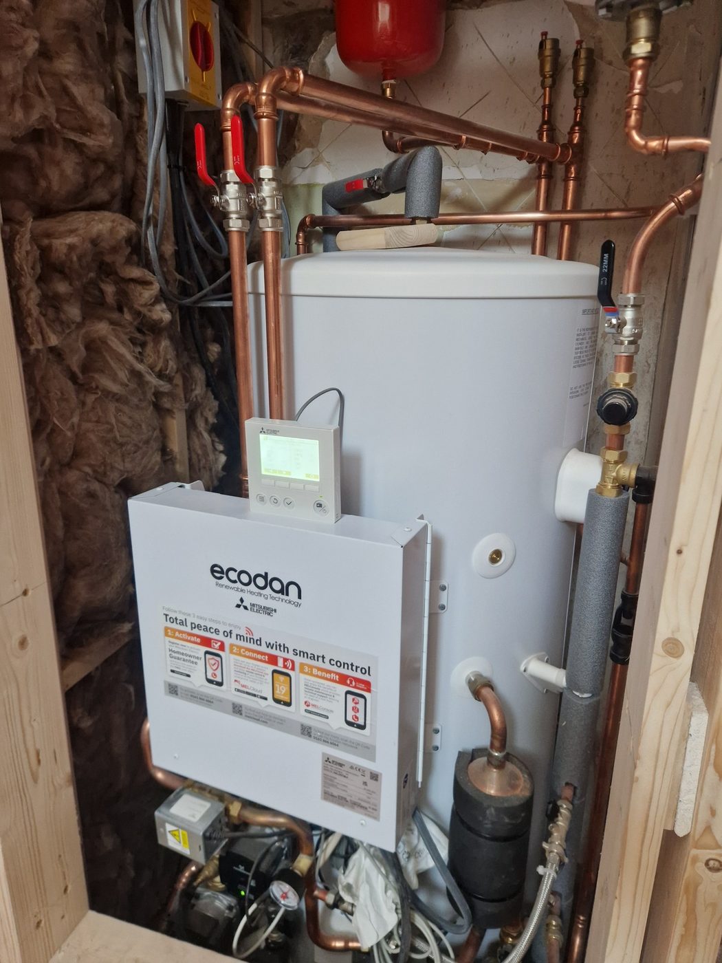 An Ecodan hydrobox and hot water cylinder installed in a timber-framed cupboard