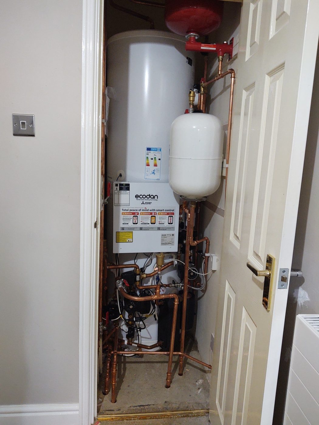 Pre-plumbed cylinder, expansion vessel and copper pipework in a cupboard on the same Cinderford job