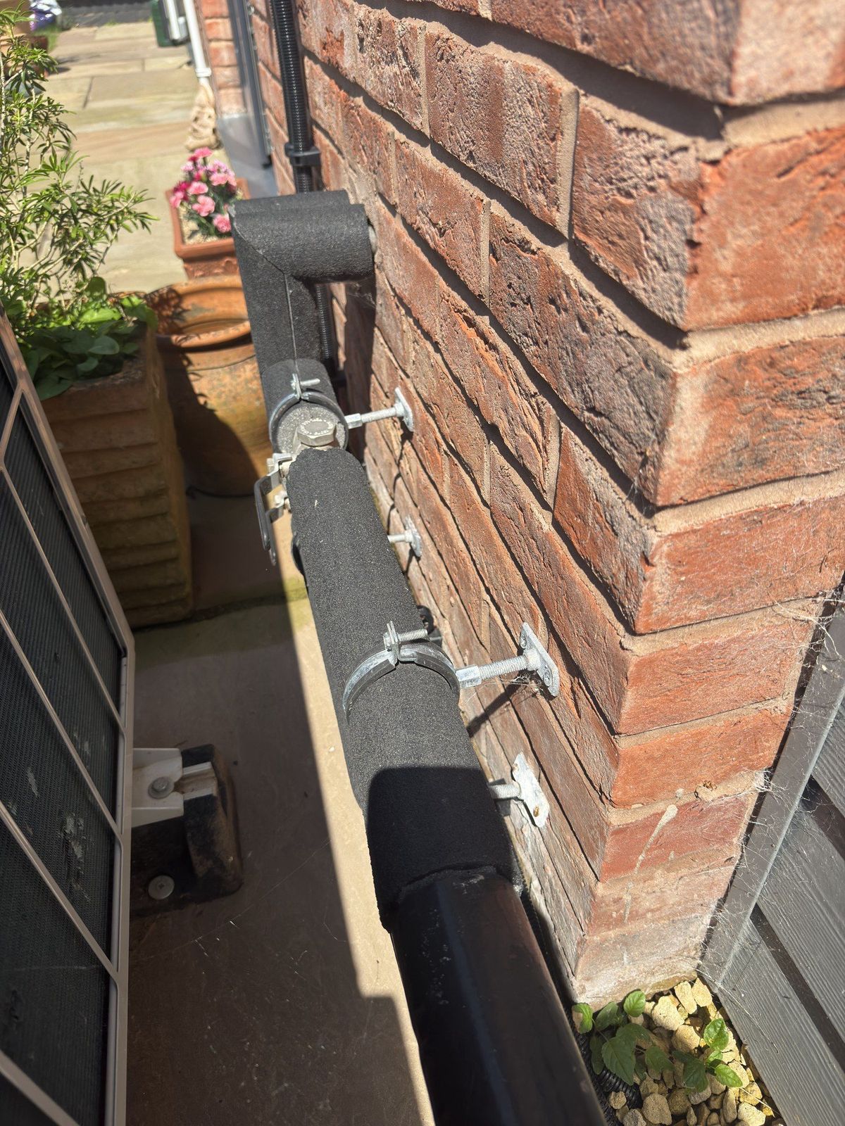Split and gapped pipe insulation on external heat pump pipework, found during a service on a system installed by another company