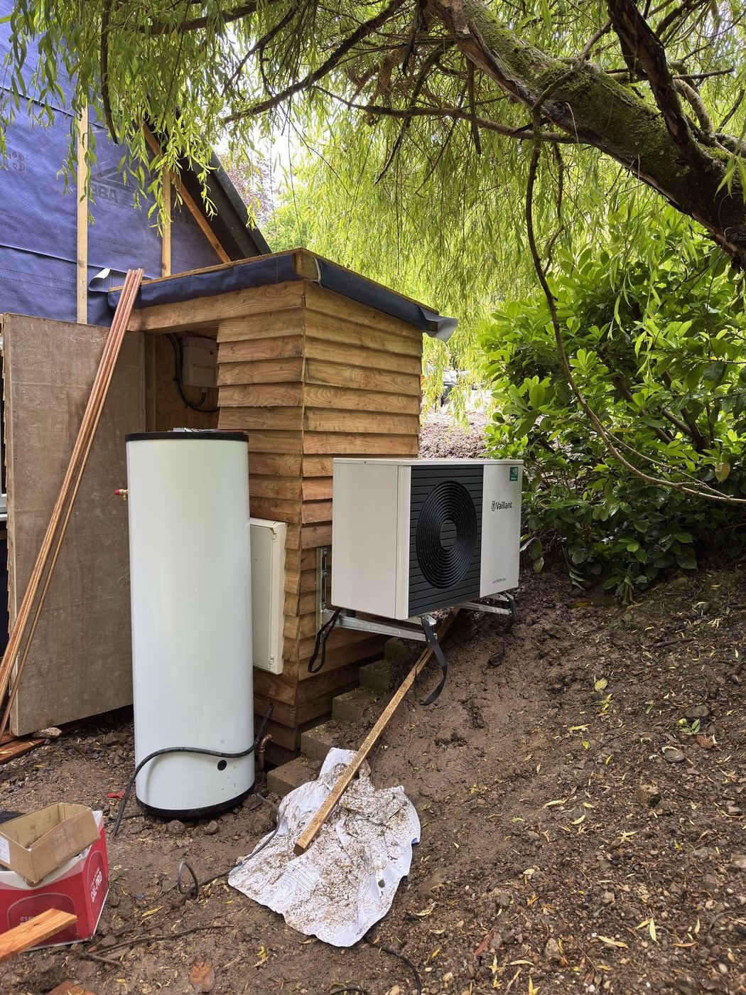 Hot water cylinder and outdoor unit on site during an installation
