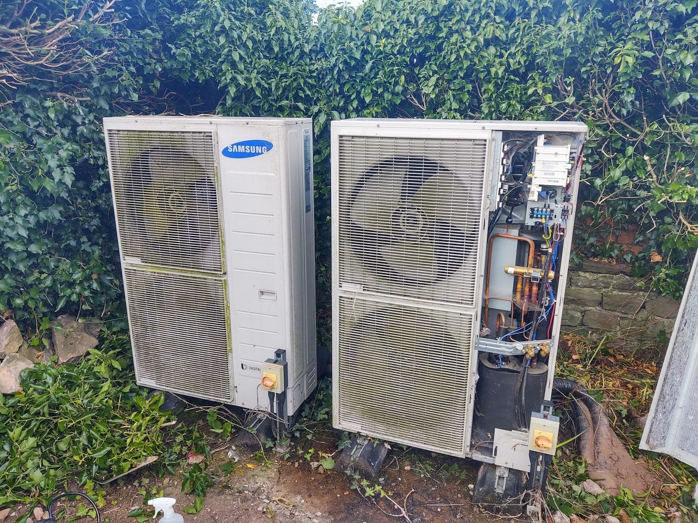 A pair of air source heat pumps supplying one property, attended for repair and service