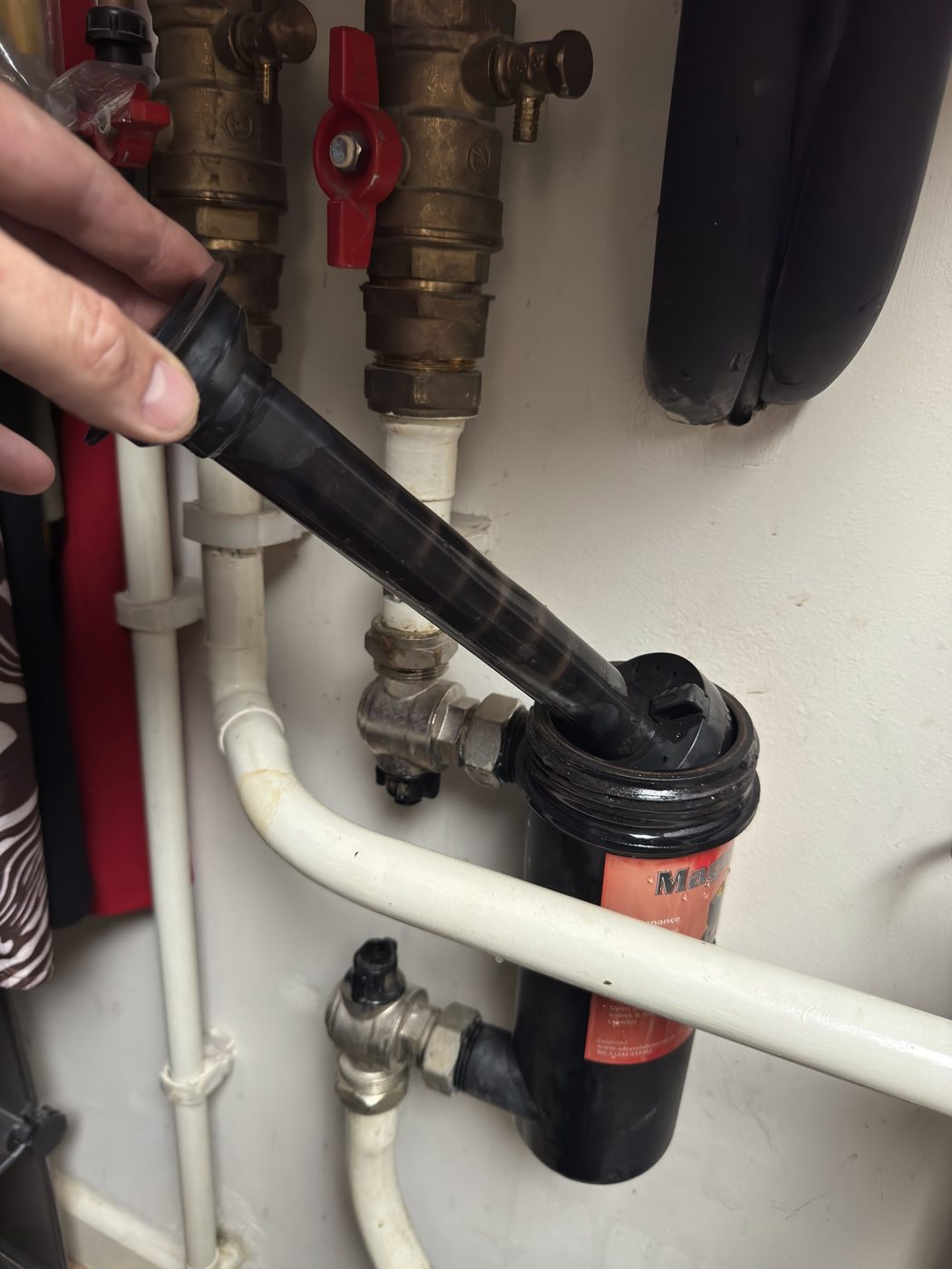 A magnetic system filter opened up during a service, the magnet being lifted out of the canister