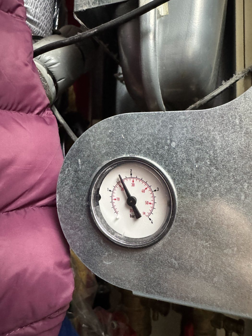 A system pressure gauge being read during a heat pump service