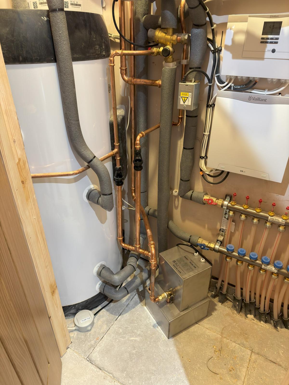 Underfloor heating manifold, pump and pipework in a plant cupboard